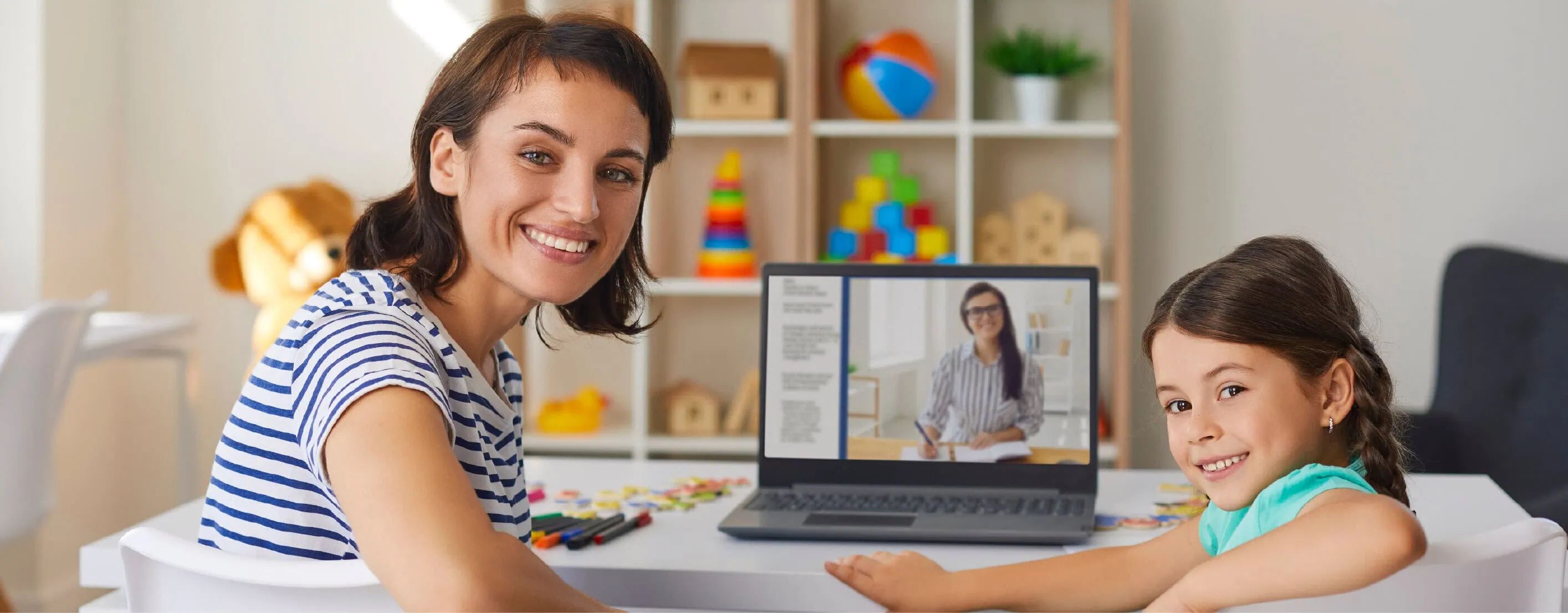A parent and child at a laptop during an online tutoring session